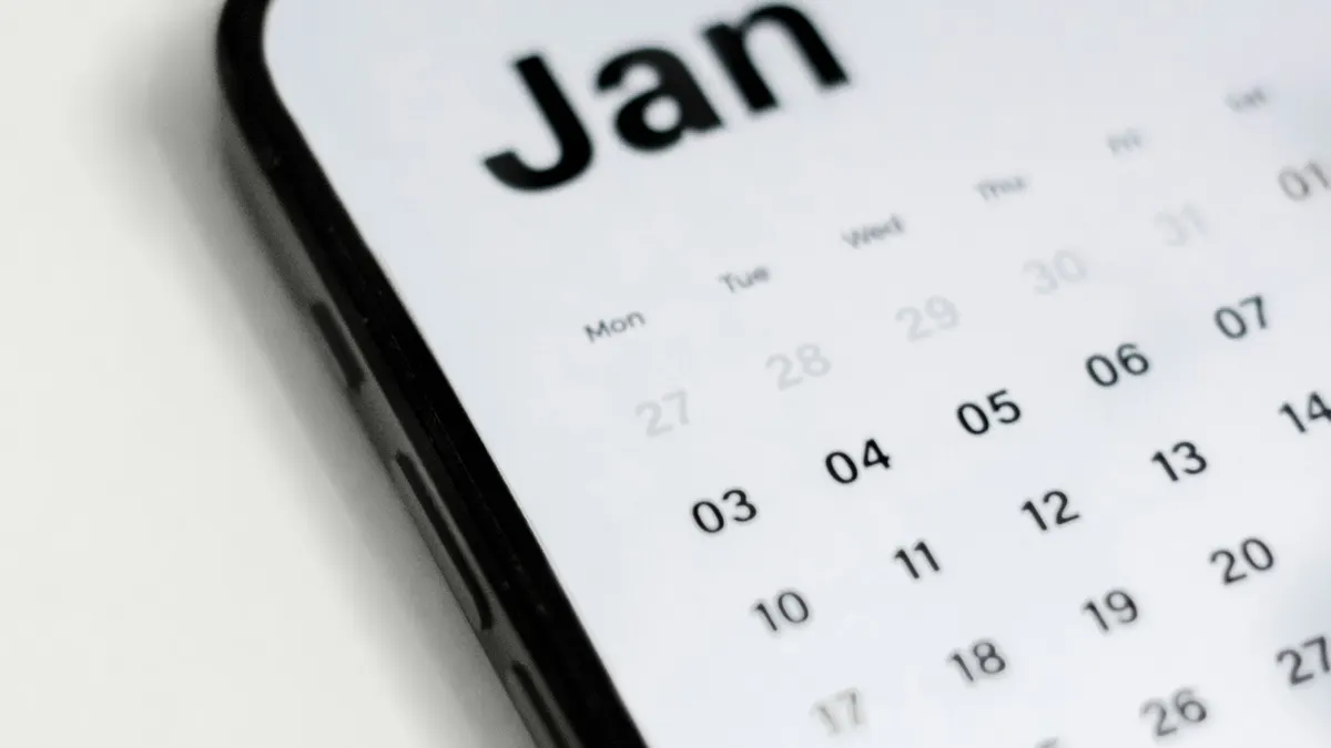 Kalender und Smartphone mit Streaming-App symbolisieren Laufzeit eines IPTV Abos